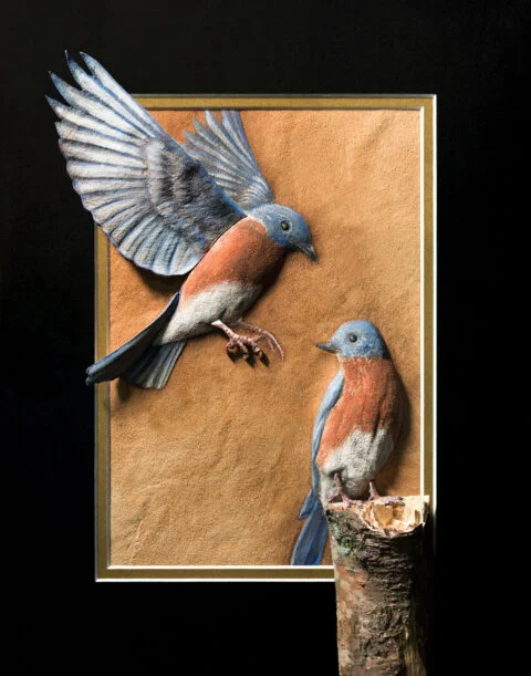 Photo of the Bluebirds burned on buckskin leather and finished with natural pigments and primitive tools.