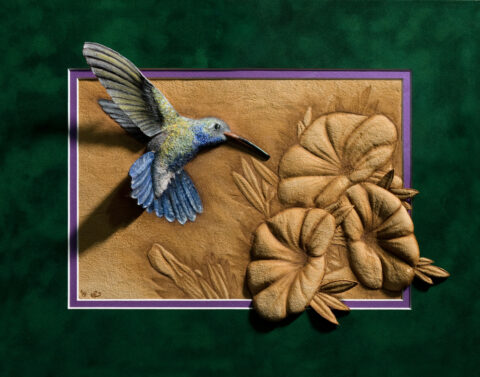 Photo of the Hummingbird burned on buckskin leather and finished with natural pigments and primitive tools.